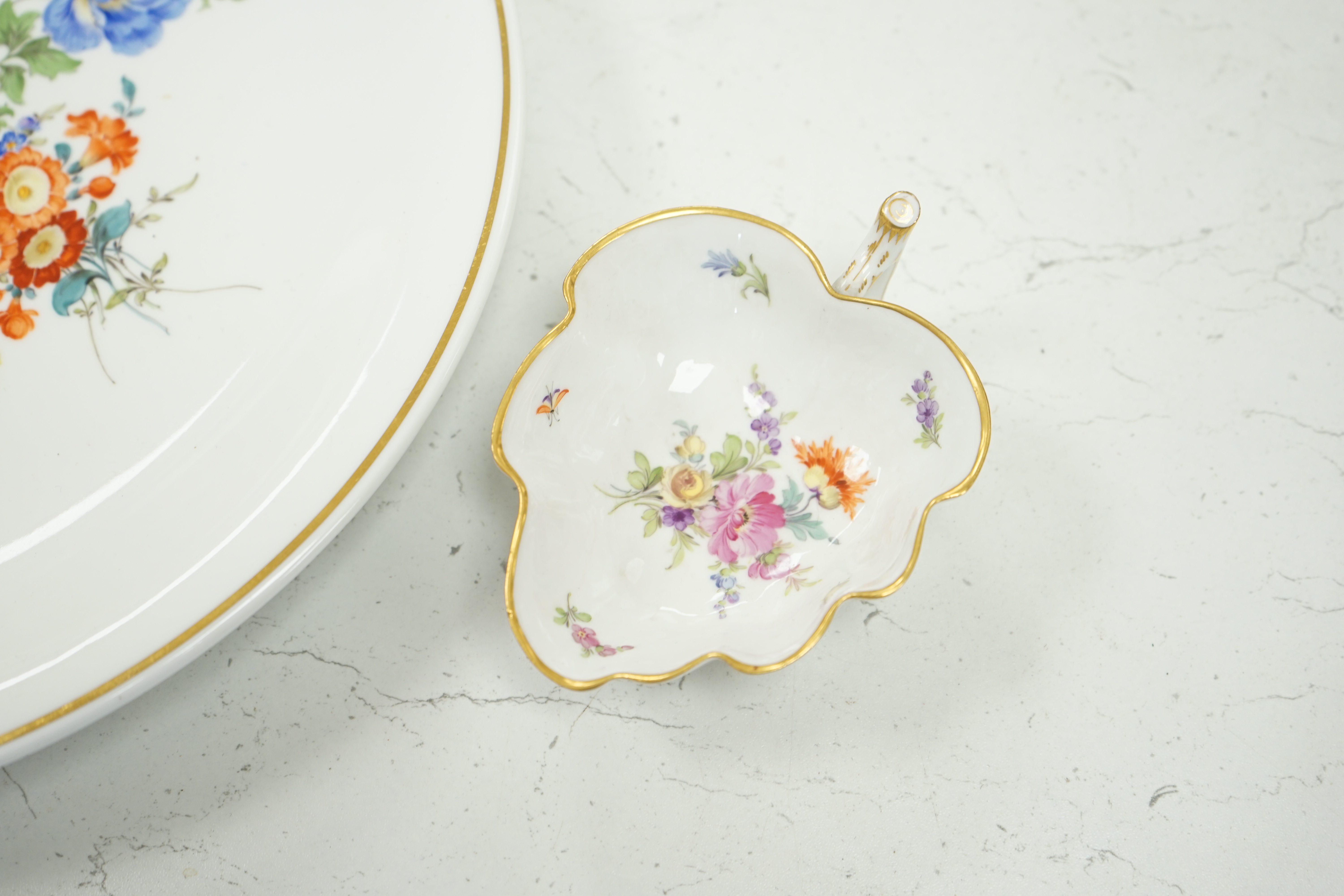 A 20th century Meissen floral painted dish and a similar leaf pickle dish, 31cm in diameter. Condition - good